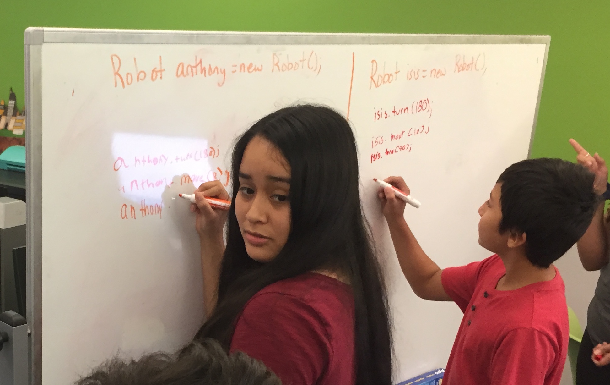 Students writing on whiteboard